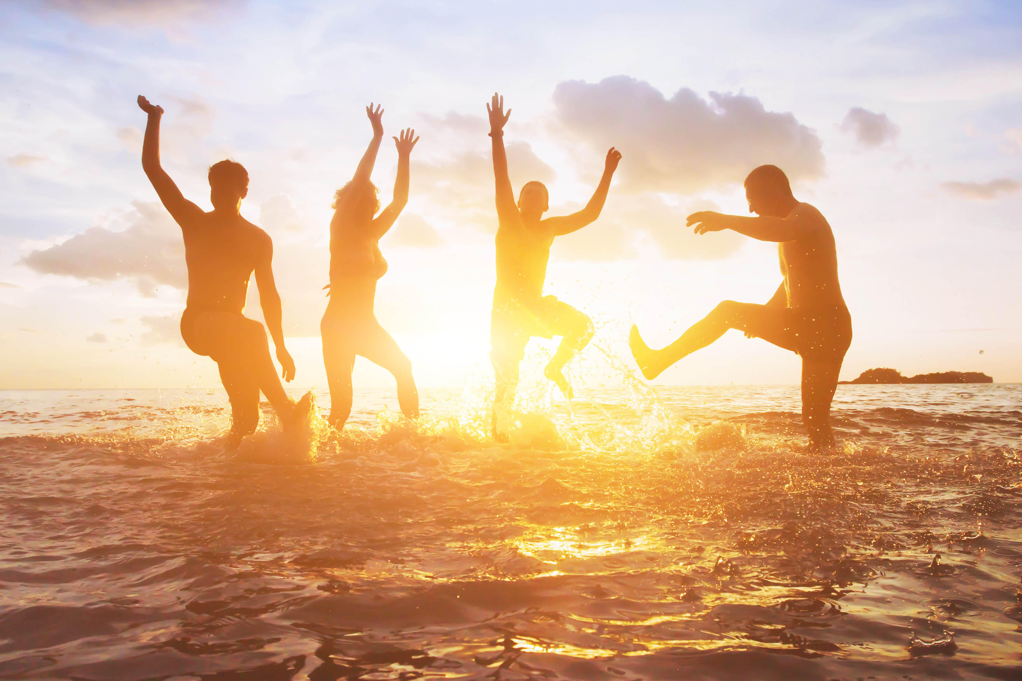 Group splashing in the sunshine in a lake